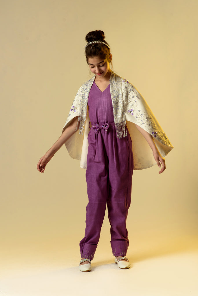 Moonbeam Glimmer is an Organic Herringbone Jumpsuit With Embroidered Cape Shawl and Bow Belt For Girls.